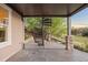 Stylish covered back patio with stamped concrete and unique spiral staircase at 4704 Cedar Glen Pl, Castle Rock, CO 80109