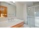 A well-lit bathroom featuring a single sink, a shower with glass doors, and tile flooring at 4704 Cedar Glen Pl, Castle Rock, CO 80109