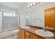 Bathroom featuring double sinks, a shower with glass doors, and a vanity at 4704 Cedar Glen Pl, Castle Rock, CO 80109