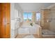Bright bathroom featuring a soaking tub and a glass shower at 4704 Cedar Glen Pl, Castle Rock, CO 80109