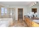 Bright bathroom with a soaking tub, glass shower, and double vanity at 4704 Cedar Glen Pl, Castle Rock, CO 80109