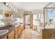 Spacious bathroom with double vanity, glass shower, and bathtub with doors leading to main bedroom at 4704 Cedar Glen Pl, Castle Rock, CO 80109