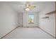 Clean, carpeted bedroom with a window providing ample natural light, and floating shelves at 4704 Cedar Glen Pl, Castle Rock, CO 80109
