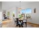 Bright dining area with a modern chandelier, a round table, and an adjacent living space at 4704 Cedar Glen Pl, Castle Rock, CO 80109