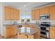 Well-lit kitchen with stainless steel appliances, granite countertops, and a charming center island at 4704 Cedar Glen Pl, Castle Rock, CO 80109