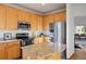 Spacious kitchen featuring light wood cabinets, stainless steel appliances, and granite countertops at 4704 Cedar Glen Pl, Castle Rock, CO 80109
