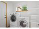 Bright laundry room with a window, washer, dryer, and shelving at 4704 Cedar Glen Pl, Castle Rock, CO 80109
