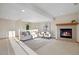 Cozy living room with a fireplace, a sofa, two chairs, and a patterned rug at 4704 Cedar Glen Pl, Castle Rock, CO 80109