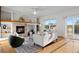 Comfortable living room with a fireplace, built-in shelving, and a sliding glass door to the outside at 4704 Cedar Glen Pl, Castle Rock, CO 80109