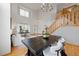Bright open-concept living room featuring a stunning chandelier, hardwood floors, and staircase at 4704 Cedar Glen Pl, Castle Rock, CO 80109