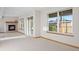 Spacious room with a fireplace, large windows, and sliding glass doors to outdoor space at 4704 Cedar Glen Pl, Castle Rock, CO 80109