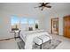 Spacious primary bedroom featuring a ceiling fan and ensuite bathroom with a shower at 4704 Cedar Glen Pl, Castle Rock, CO 80109