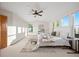 Bright primary bedroom featuring multiple windows, modern decor, and a ceiling fan at 4704 Cedar Glen Pl, Castle Rock, CO 80109