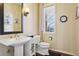 Half bathroom with gold accents, and a pedestal sink at 19113 E Fair Dr, Aurora, CO 80016