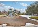 Community playground featuring slides, climbing wall, and swing sets surrounded by snow-dusted ground at 19113 E Fair Dr, Aurora, CO 80016