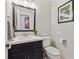 A modern bathroom with a stylish vanity, mirror, light fixture, toilet, and minimalist décor at 9290 N Raleigh St, Westminster, CO 80031