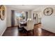 Dining room with hardwood floors, modern light fixture, and a view into the updated kitchen at 9290 N Raleigh St, Westminster, CO 80031