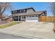 Two-story home with a two car garage, beautiful green lawn and mature trees at 9290 N Raleigh St, Westminster, CO 80031
