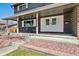 Charming front porch featuring white columns, brick facade, and rocking chairs at 9290 N Raleigh St, Westminster, CO 80031