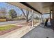 Covered front porch with an outdoor seating area and brick support columns at 9290 N Raleigh St, Westminster, CO 80031
