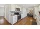 Modern kitchen features stainless steel appliances, white cabinetry, and hardwood floors at 9290 N Raleigh St, Westminster, CO 80031