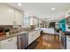 Bright, updated kitchen featuring stainless steel appliances, white cabinets, and hardwood floors at 9290 N Raleigh St, Westminster, CO 80031
