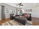 Stylish living room featuring hardwood floors, a comfortable sofa, an ottoman, and a large window with natural light at 9290 N Raleigh St, Westminster, CO 80031