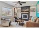 Cozy living room with a fireplace, comfortable seating, and a large window with natural light at 9290 N Raleigh St, Westminster, CO 80031