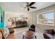 Bright living room featuring a ceiling fan, tile flooring, an open doorway to the kitchen, and comfortable seating at 9290 N Raleigh St, Westminster, CO 80031