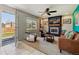 Comfortable living room with tile flooring, a fireplace, modern chairs, and an open view to the backyard at 9290 N Raleigh St, Westminster, CO 80031