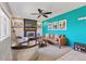 Cozy living room with fireplace, mounted TV, modern furniture, and a vibrant accent wall creating a stylish atmosphere at 9290 N Raleigh St, Westminster, CO 80031