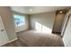 A carpeted bedroom with a large window allowing natural light at 16810 Mckay Dr, Mead, CO 80542