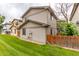 A well-maintained backyard features a lush lawn and a wooden fence for privacy at 9328 Fenton Ct, Westminster, CO 80031
