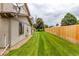 A spacious backyard offers a large grassy area and a tall wooden fence at 9328 Fenton Ct, Westminster, CO 80031