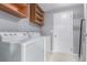 Laundry room with washer, dryer, and overhead shelving at 9328 Fenton Ct, Westminster, CO 80031