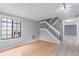Bright living room with a staircase, light hardwood floors, and a large window at 9328 Fenton Ct, Westminster, CO 80031