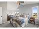 Cozy bedroom with a wrought-iron bed frame, soft carpeting, and natural light at 9145 Sugarstone Cir, Highlands Ranch, CO 80130