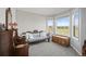 Calm bedroom with bay windows, soft carpet, and comfortable couch at 9145 Sugarstone Cir, Highlands Ranch, CO 80130
