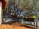 A cozy deck setting with seating, planters and lovely tree coverage to provide ample shade at 9145 Sugarstone Cir, Highlands Ranch, CO 80130