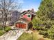 Charming two-story home features a stone-clad garage and a well-manicured lawn at 9145 Sugarstone Cir, Highlands Ranch, CO 80130