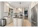 Bright eat-in kitchen featuring white cabinets, a center island, and stainless steel appliances at 9145 Sugarstone Cir, Highlands Ranch, CO 80130