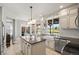 Spacious kitchen with a large island, white cabinets, and stainless steel appliances at 9145 Sugarstone Cir, Highlands Ranch, CO 80130