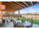 Covered patio with comfortable seating and a dining area, perfect for outdoor entertaining at 9145 Sugarstone Cir, Highlands Ranch, CO 80130