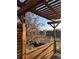 Cozy outdoor space featuring a wooden pergola offering views of a blossoming tree and open field at 9145 Sugarstone Cir, Highlands Ranch, CO 80130