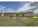 An image of the backyard featuring a large grassy area and the back of the home at 13805 W 82Nd Ave, Arvada, CO 80005