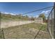 Chain link fence and shed in this grassy, partially fenced backyard at 13805 W 82Nd Ave, Arvada, CO 80005