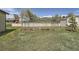 Large fenced dog run area in a spacious green backyard with shade trees at 13805 W 82Nd Ave, Arvada, CO 80005