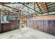 Spacious barn interior featuring stalls, exposed rafters, and natural light at 13805 W 82Nd Ave, Arvada, CO 80005