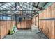 Well-maintained barn interior featuring stalls, and natural light, with gravel floor at 13805 W 82Nd Ave, Arvada, CO 80005