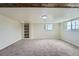 Finished basement with carpeted floor, built-in shelving and window at 13805 W 82Nd Ave, Arvada, CO 80005